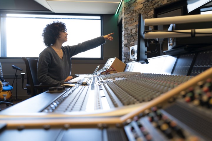 young-curly-hair-caucasian-woman-working-in-a-musi-2023-11-27-05-16-33-utc (Small)